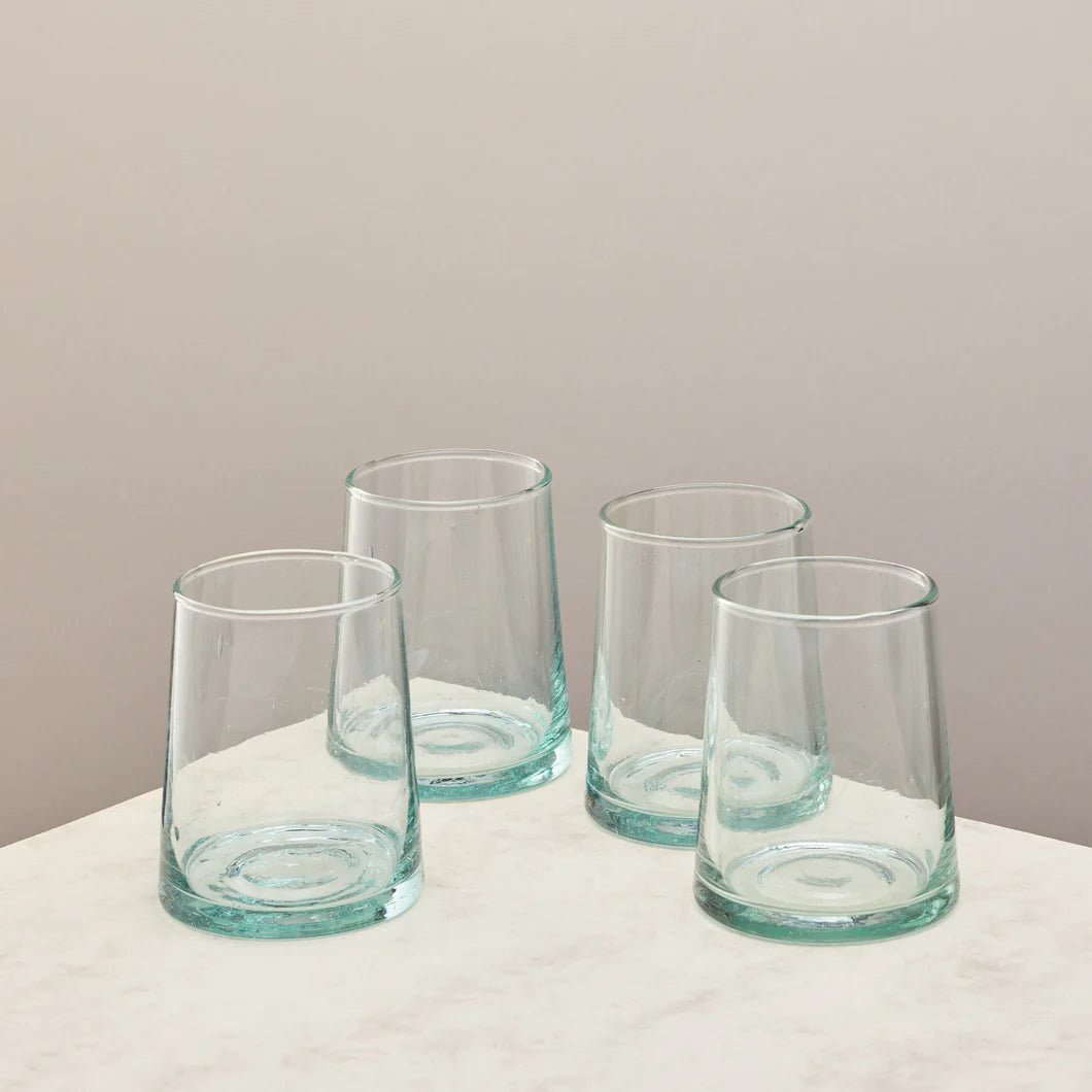 4 Hand blown Glasses on plinth with pink backdrop. 